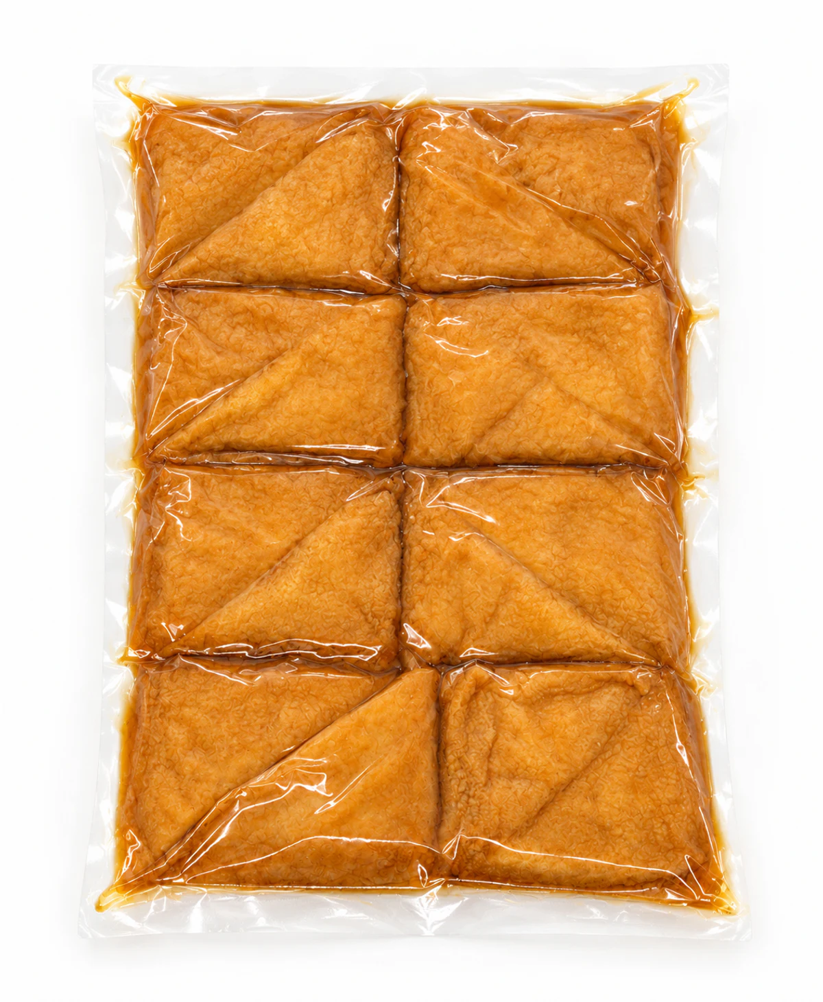Top view of triangular Seasoned Inari Tofu Pockets in an unbranded clear vacuum-sealed inner bag